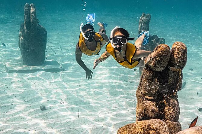 Deluxe Catamaran to Isla Mujeres with Open Bar from Cancun - Snorkeling in clear water, with a practical warning