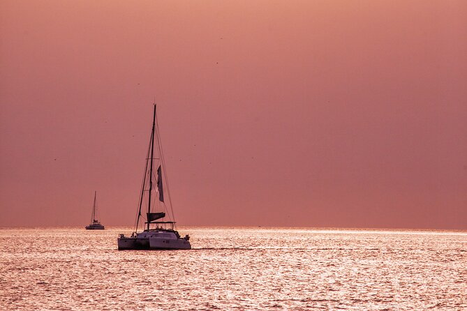Deluxe Santorini Sailing with BBQ and Drinks Shared Tour - The lighthouse and Indian Head Mountain from the catamaran