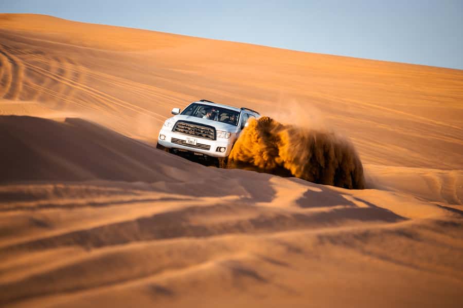 Dubai: Premium Red Dune Safari with Sandboarding & BBQ - Sandboarding and sunset photo time