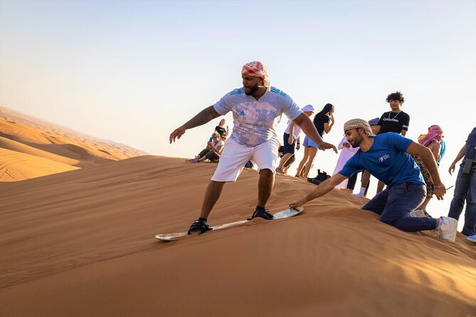 Dubai Red Dunes with Sandboarding, Camel Ride, Falcon & VIP Camp - Sandboarding with a short climb