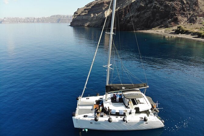 Half-Day Exclusive Catamaran Cruise in Santorini with Meal and Open Bar - From hotel pickup to Vlychada Marina