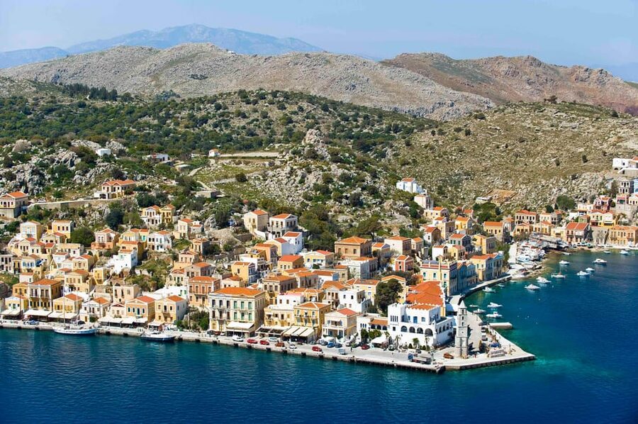 Luxury Boat Trip to Symi Island with Swimming at St. George - Arriving in Symi’s famous harbor