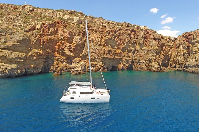 Luxury Catamaran Cruise from Athens with Traditional Greek Meal and BBQ - First swimming stop: towels, sun, and clear water