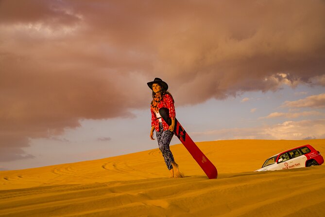 Premium Dubai Red Dunes with quadbike, camel ride and VIP Dinner - Sandboarding on the red dunes