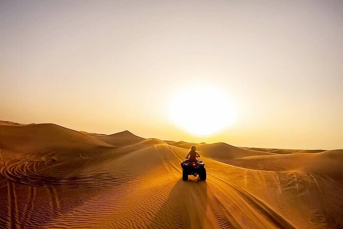 Premium Evening Desert Safari with Quad Bike, Camel Ride and BBQ Dinner - Quad biking across open sand