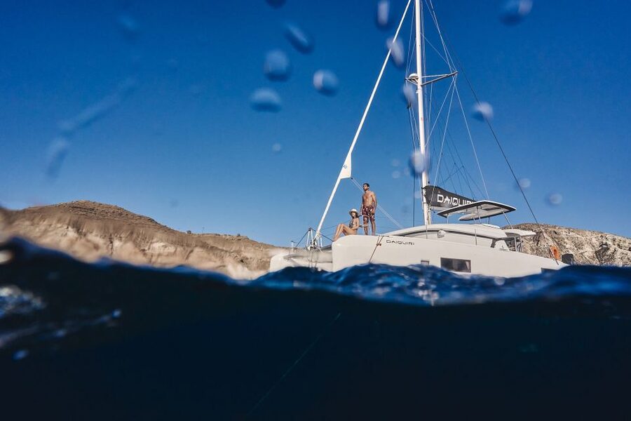 Santorini: Caldera Luxury Catamaran Cruise w/ Meal & Drinks - Red Beach: dramatic rock and the first swim
