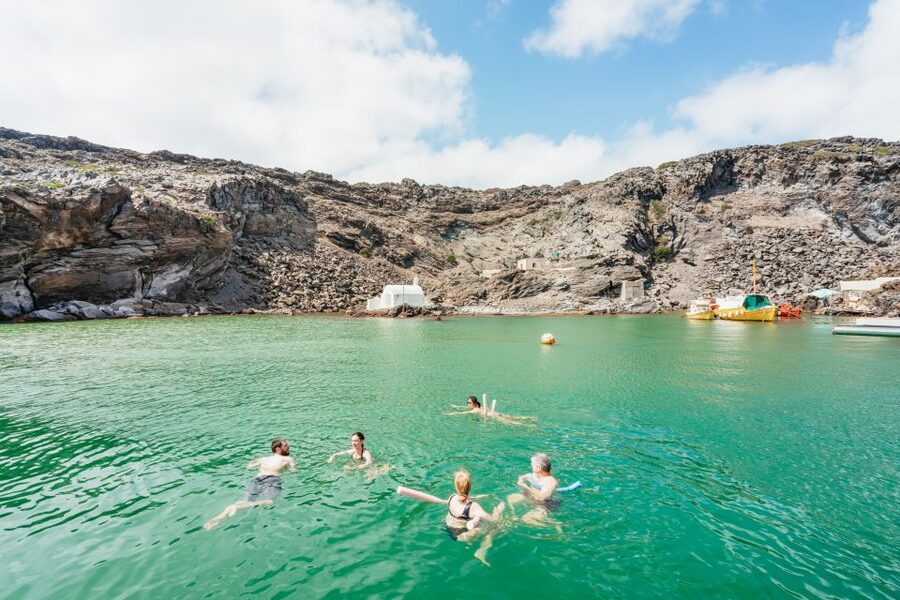 Santorini: Luxury Catamaran Day Trip with Meal and Open Bar - White Beach caves and the volcanic coast