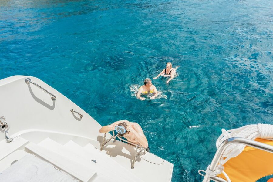 Santorini: Luxury Catamaran Day Trip with Meal and Open Bar - How the crew shapes the day